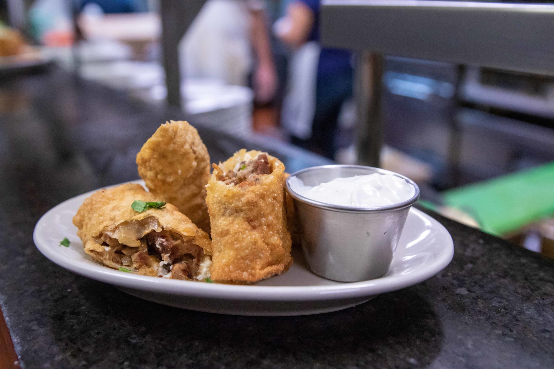 Food sits on a place of food at The Mad Greek